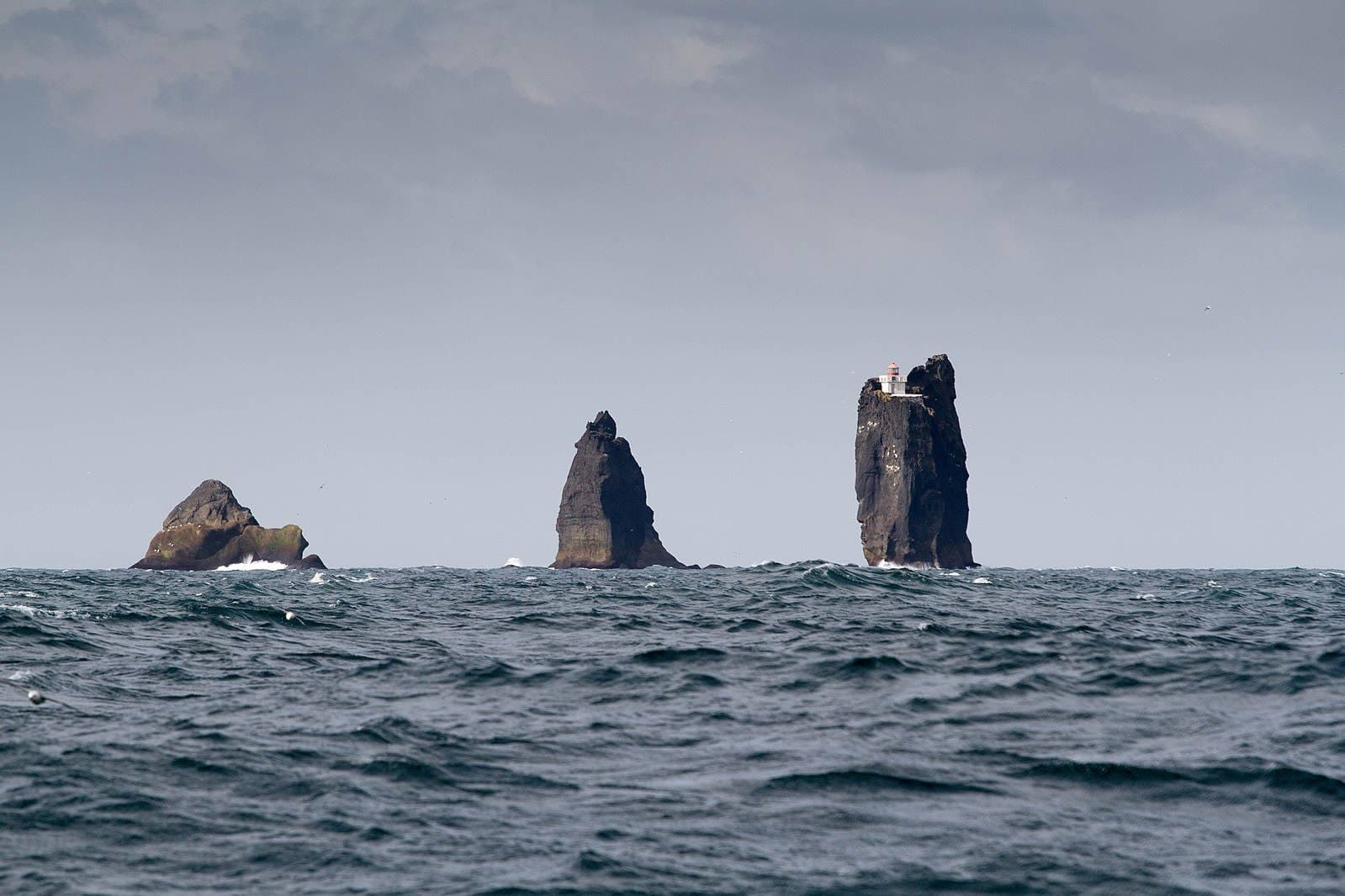 Þrídrangaviti Lighthouse on the tallest of three sea stacks rising from the Atlantic off the Westman Islands.