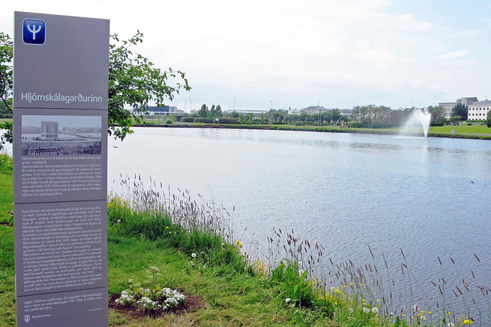 Tjörnin pond beside the Hljómskálagarðurinn sign and fountain in central Reykjavík