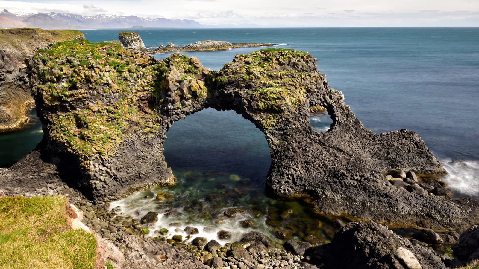 A natural basalt sea arch above the Atlantic at Arnarstapi.