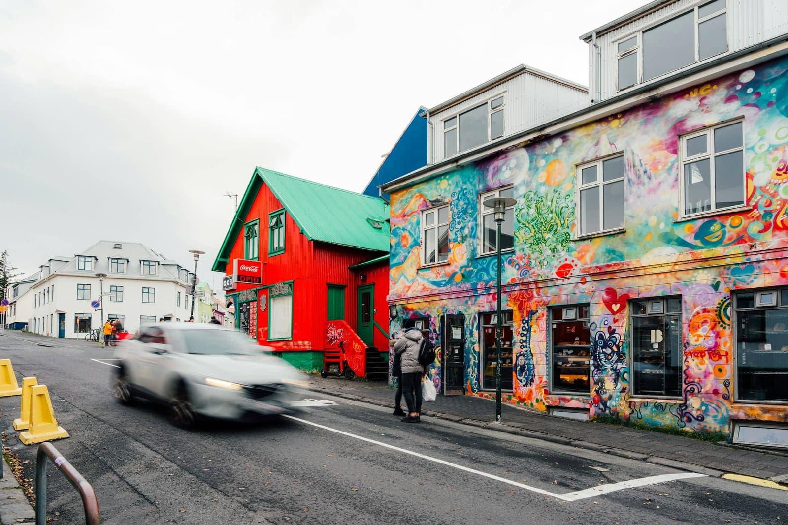 Large Reykjavik street-art mural on a city building wall.