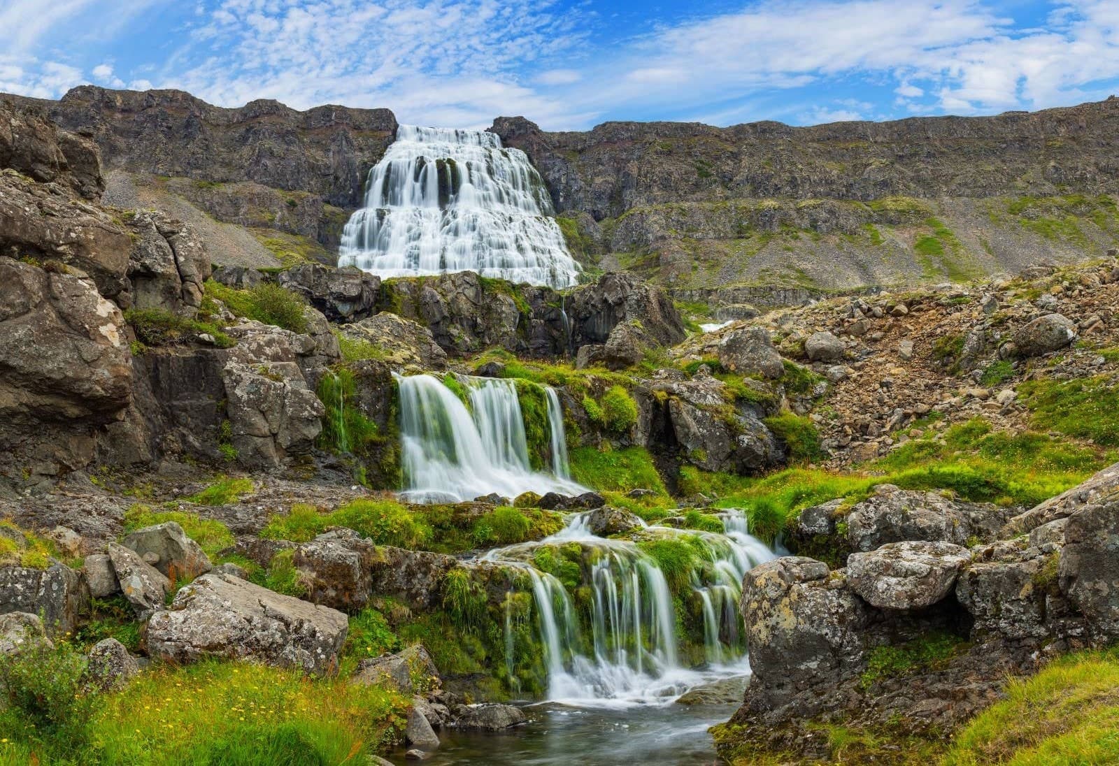 Dynjandi waterfall spreading across stepped rock above smaller cascades in the Westfjords.