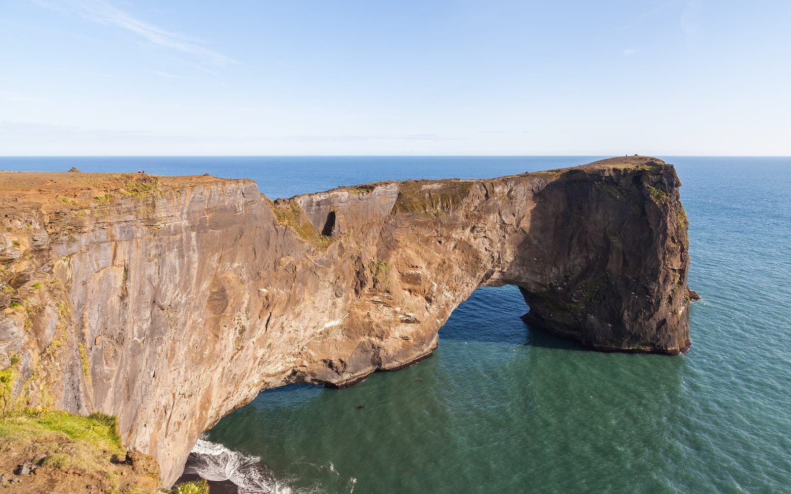 Dyrhólaey sea arch rising above the Atlantic on Iceland's South Coast