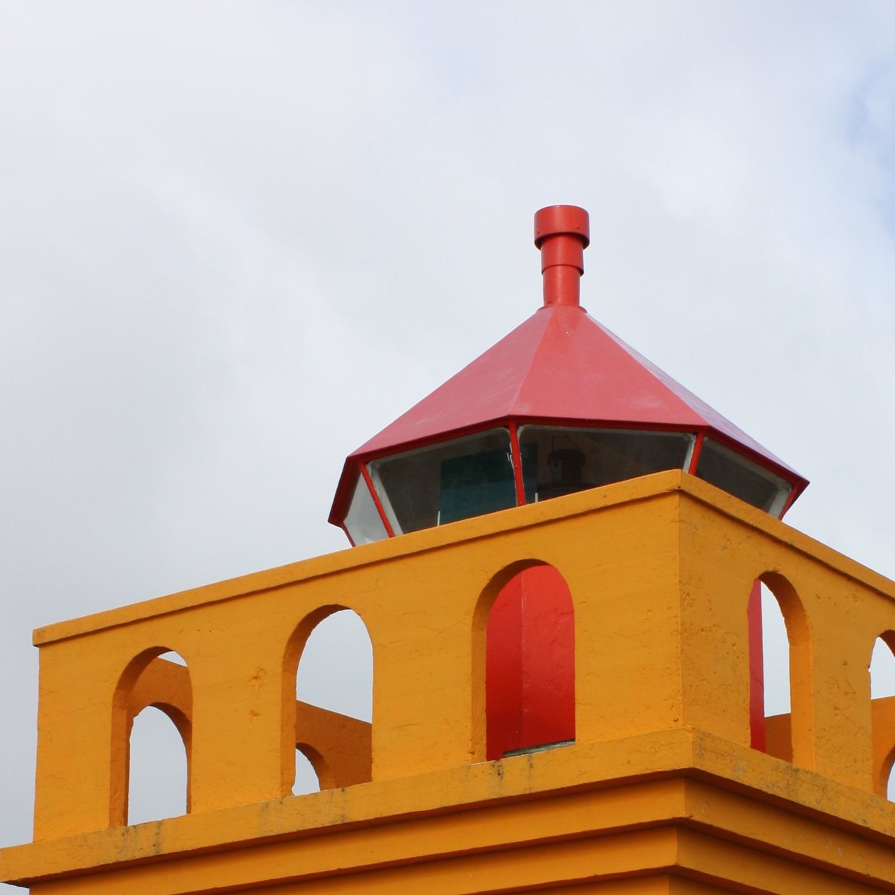Close view of the red lantern and orange concrete arches on Brimnesviti Lighthouse.