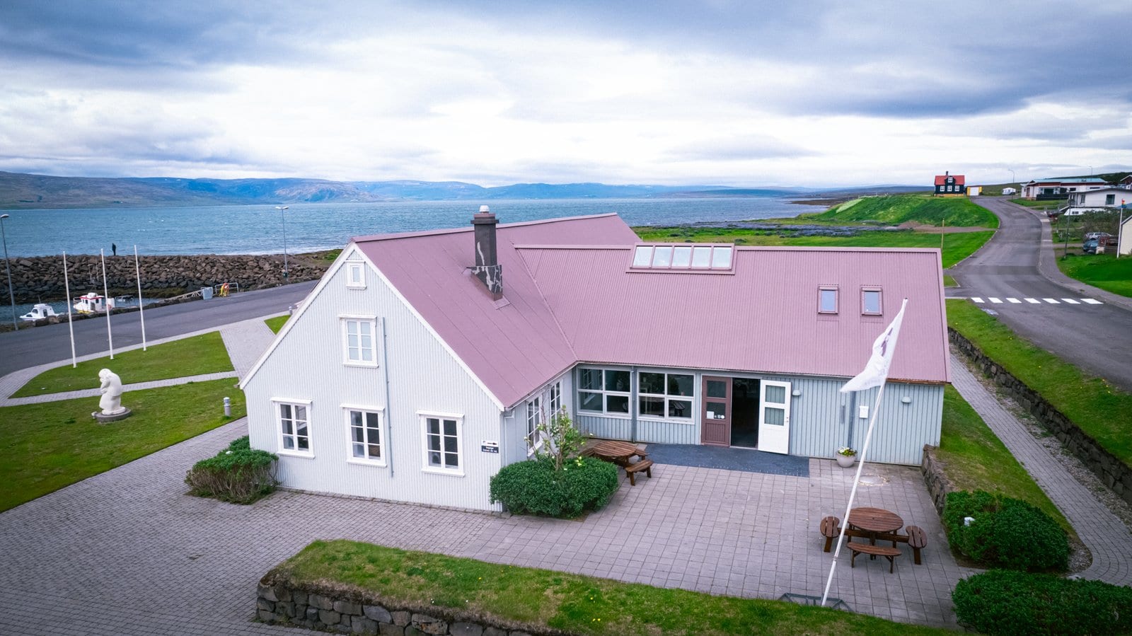 Leifsbúð building by the harbor in Búðardalur with Hvammsfjörður behind it.