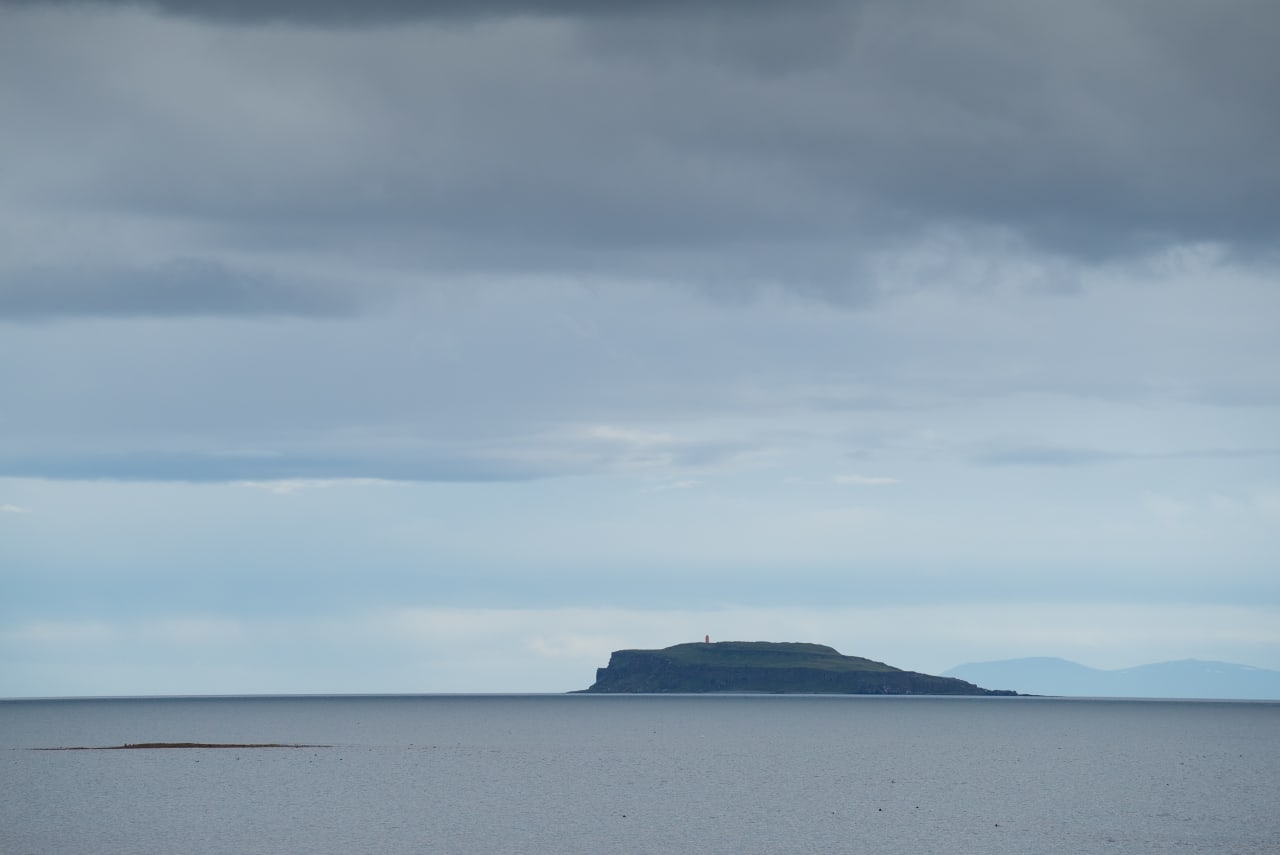 Grímsey island off Drangsnes in Steingrímsfjörður with low Westfjords hills behind.