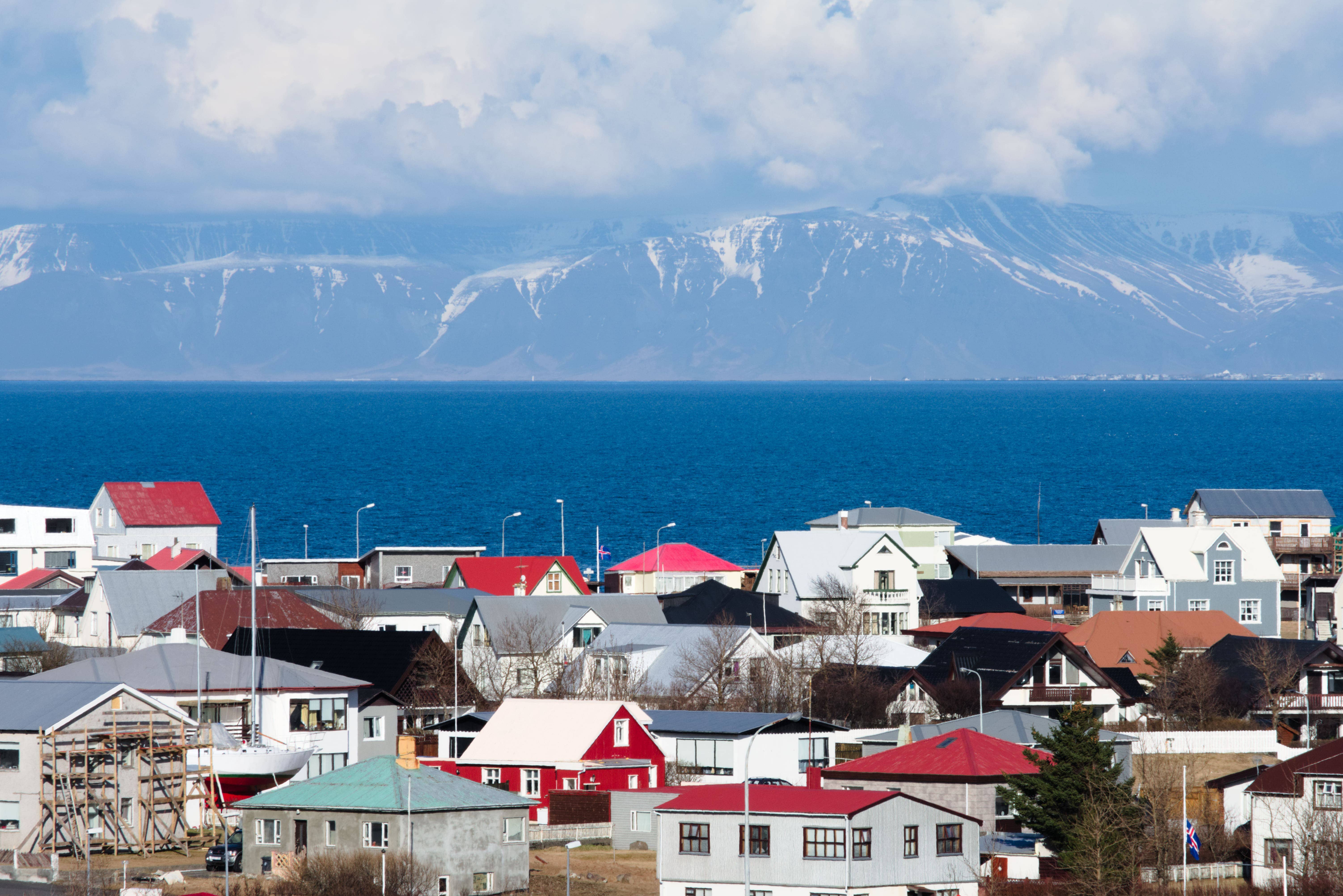 Keflavík bay and harborfront buildings under clear daylight.