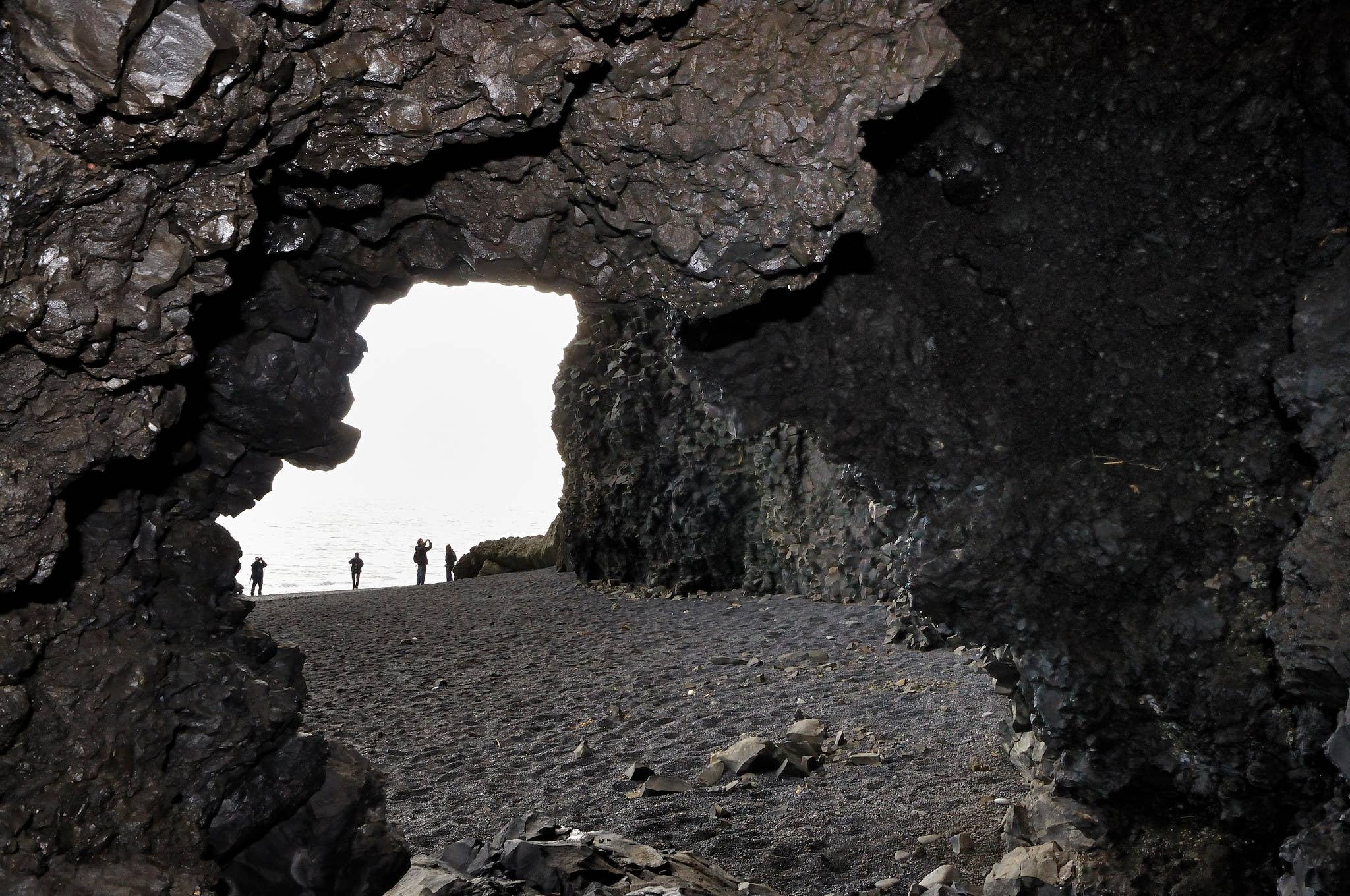 Surf and basalt cliffs around Halsanefshellir Cave at Reynisfjara