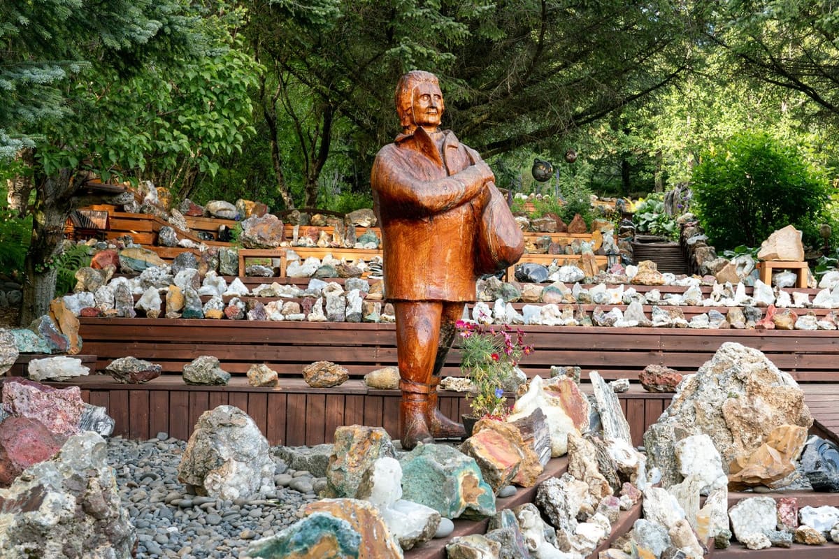 Garden statue surrounded by stone displays at Petra's Stone Collection.