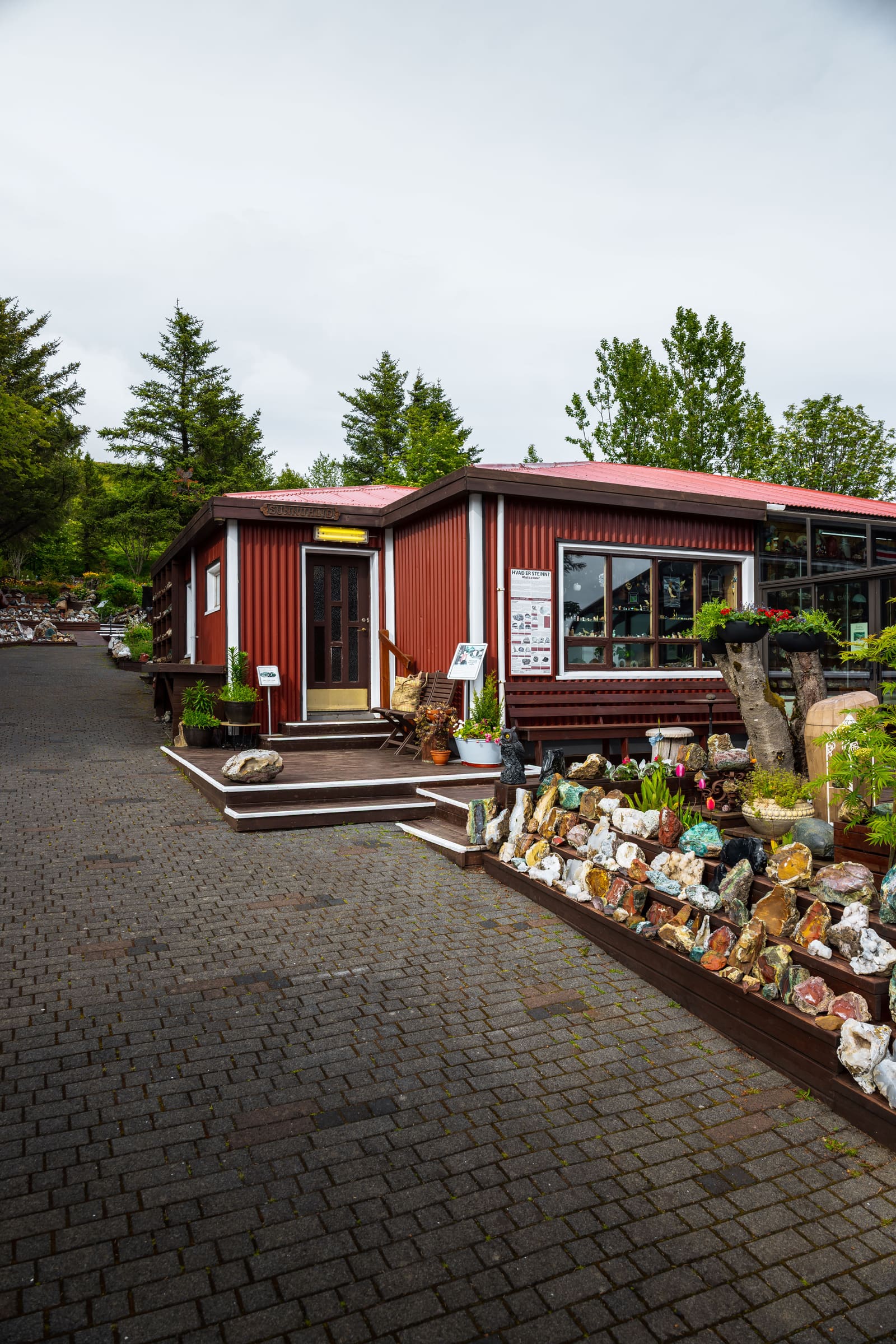Exterior of Petra's Stone Collection with stones displayed around the garden in Stodvarfjordur.