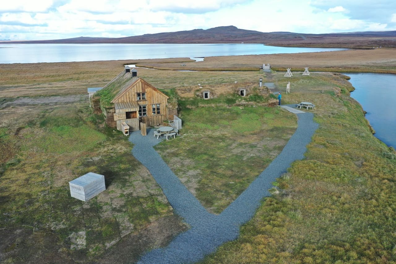 Sænautasel turf buildings and Saenautavatn lake in open East Iceland heathland.