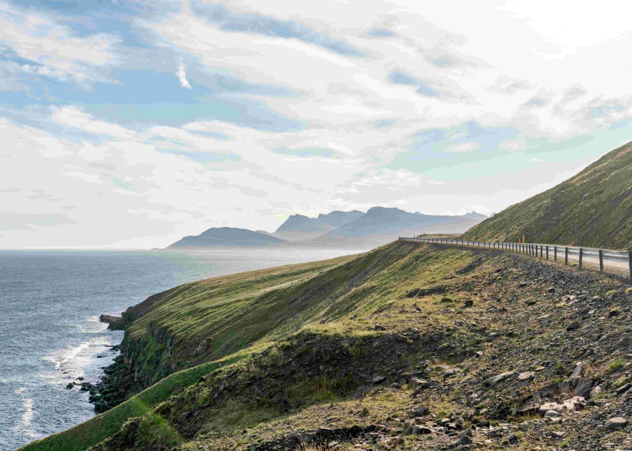 Coastal road and cliffside view near Kambanes outside Stöðvarfjörður in East Iceland.