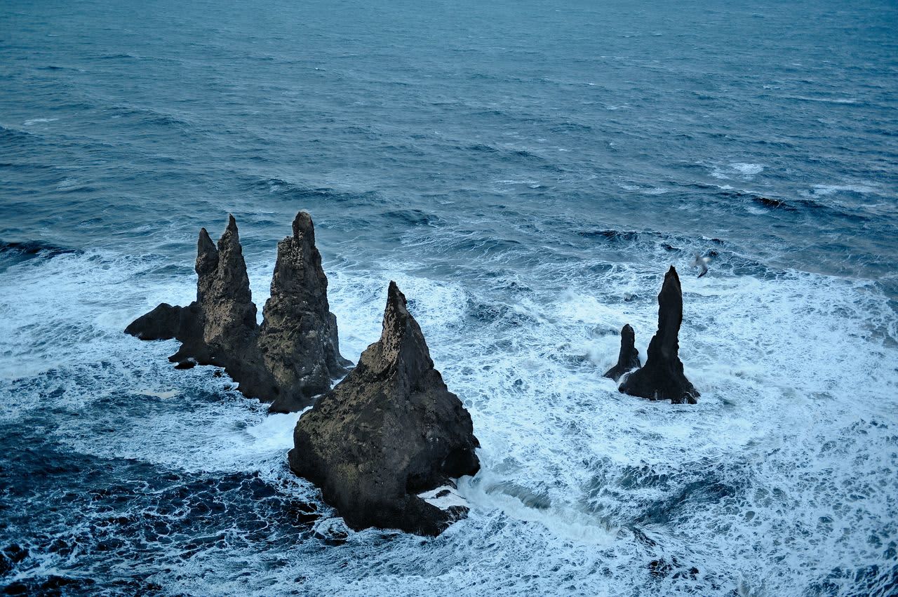 Reynisdrangar sea stacks from an elevated Vík-area angle above the Atlantic.