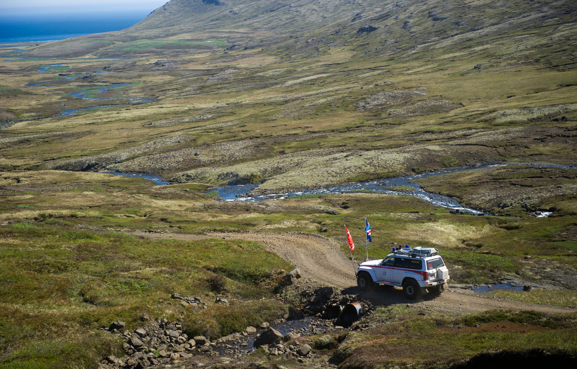 Track and broad valley on the approach side of Vöðlavík, showing how exposed and remote the bay feels before the final shore section.