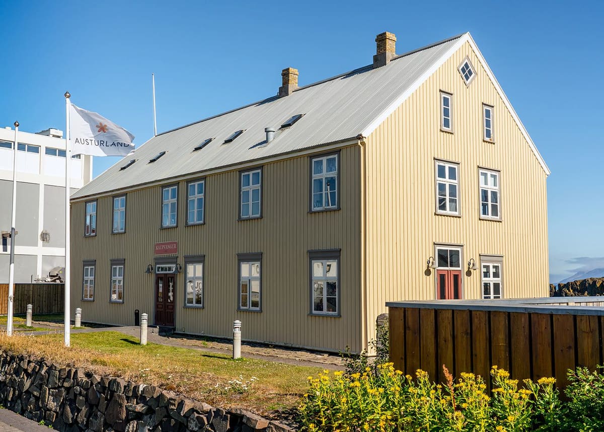 Kaupvangur cultural building in Vopnafjörður under a clear blue sky.