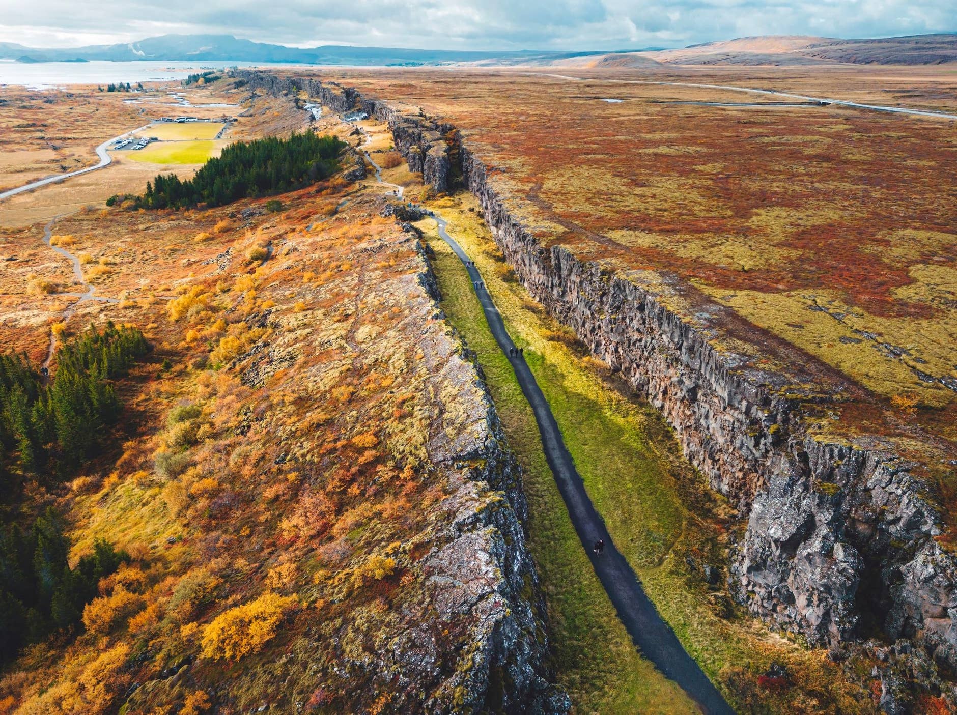 Aerial view of the Almannagjá rift path, Þingvellir roads, and Lake Þingvallavatn.