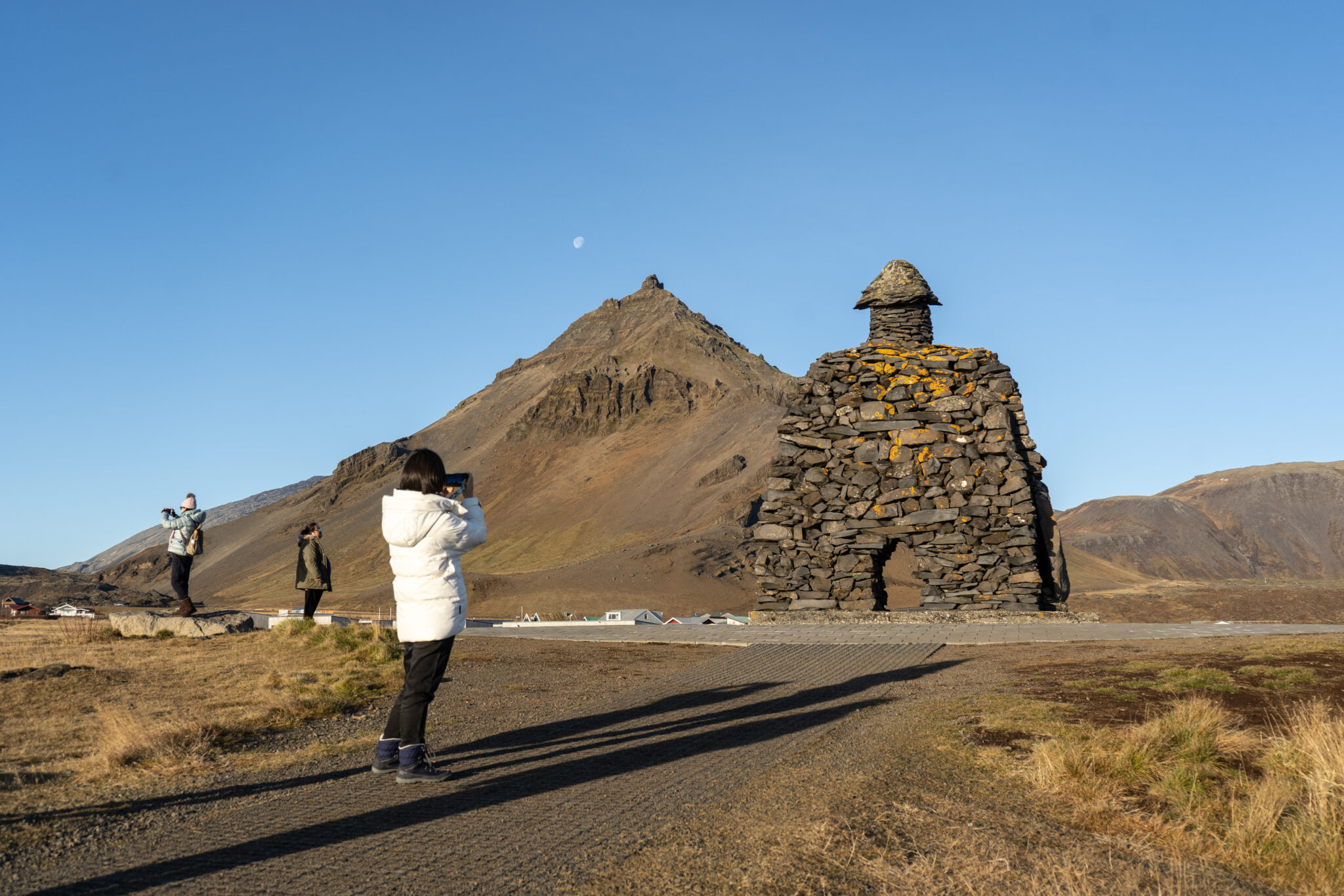 The Bárður Snæfellsás stone sculpture near Arnarstapi with Stapafell rising behind it.