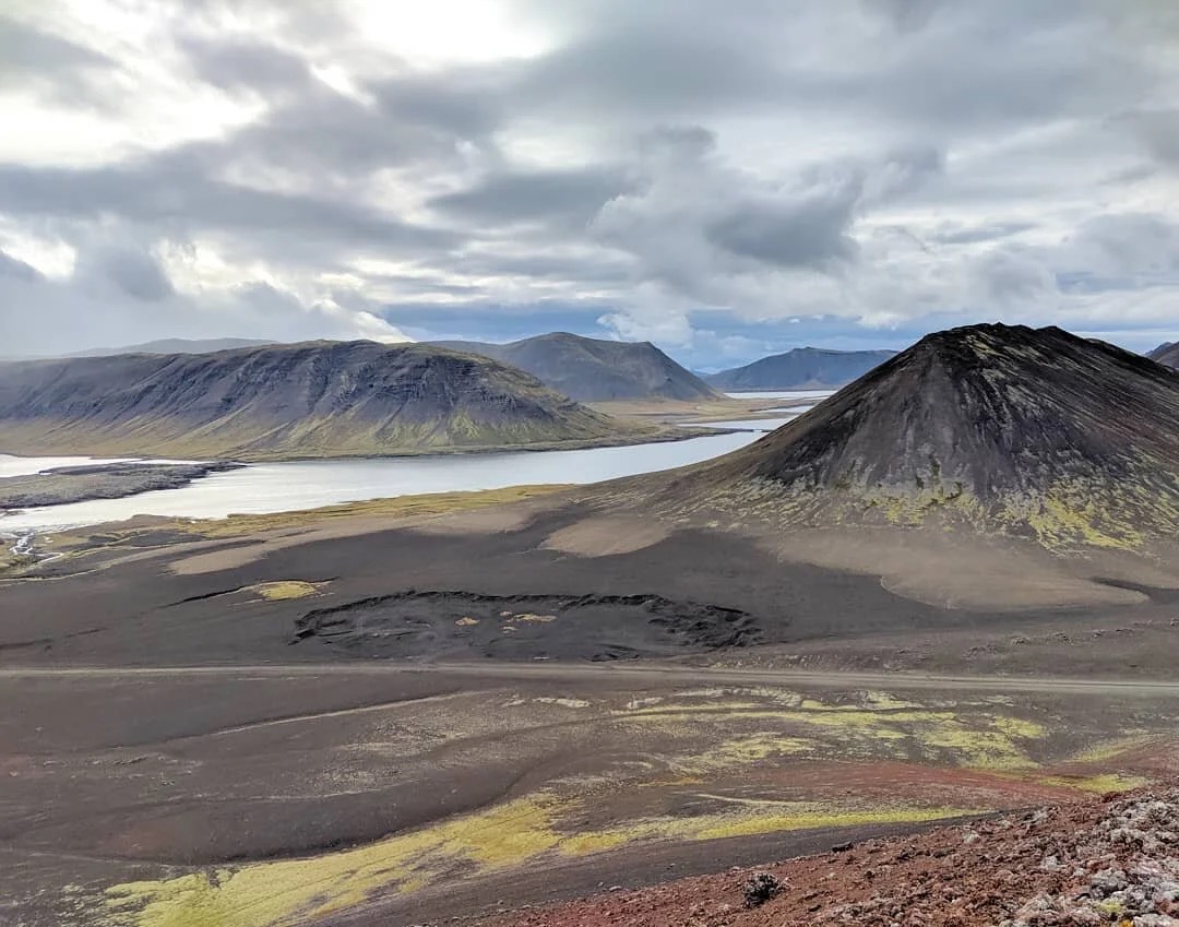 A rough road crossing the dark lava and crater landscape of Berserkjahraun.