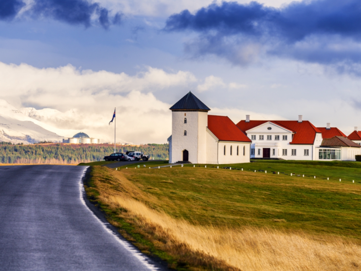Road approaching Bessastaðir with the church tower and presidential residence on Álftanes.