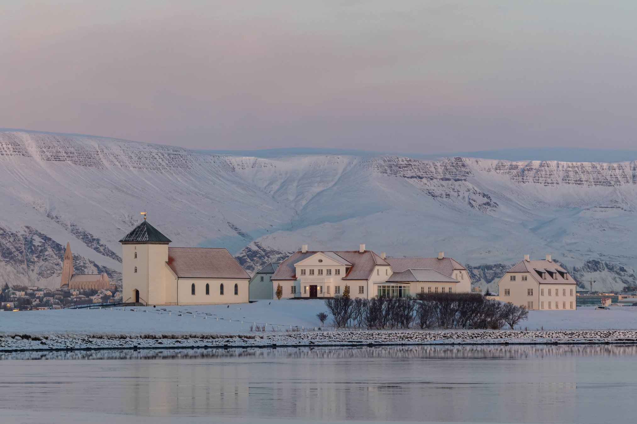 Bessastaðir presidential residence and church on Álftanes with mountains across the water.