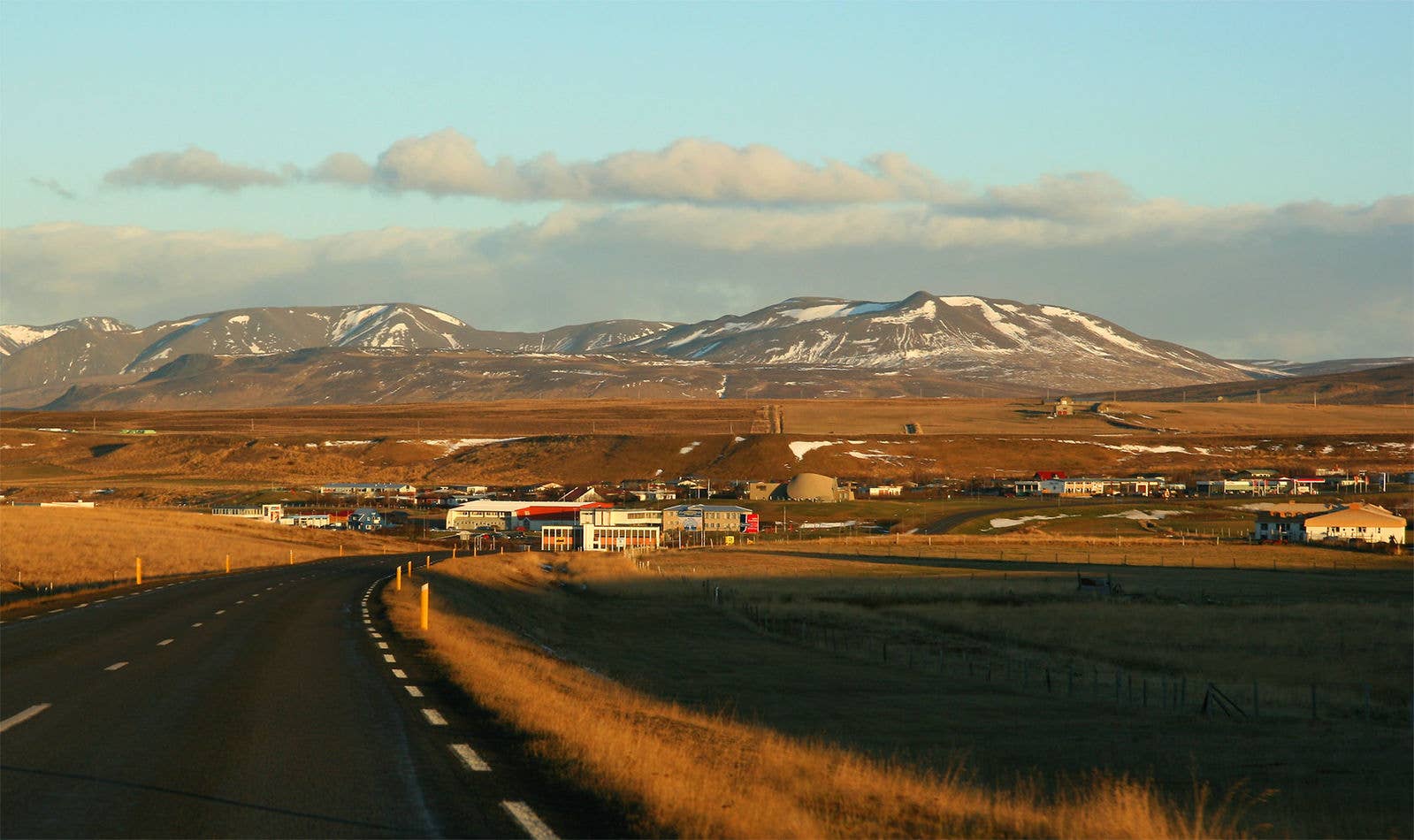 Blönduós town beside Route 1 with low North Iceland mountains in the background.