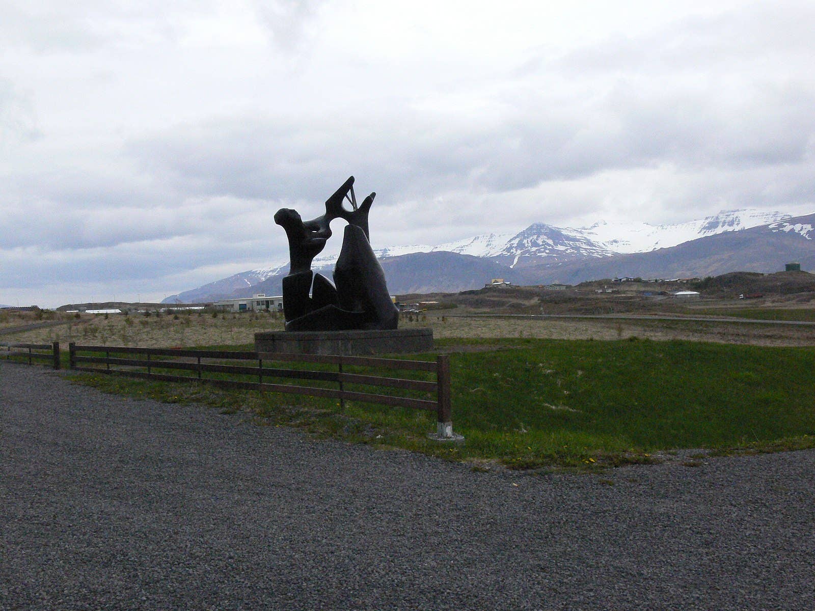 Sonatorrek sculpture at Borg á Mýrum with mountains and Borgarnes in the distance