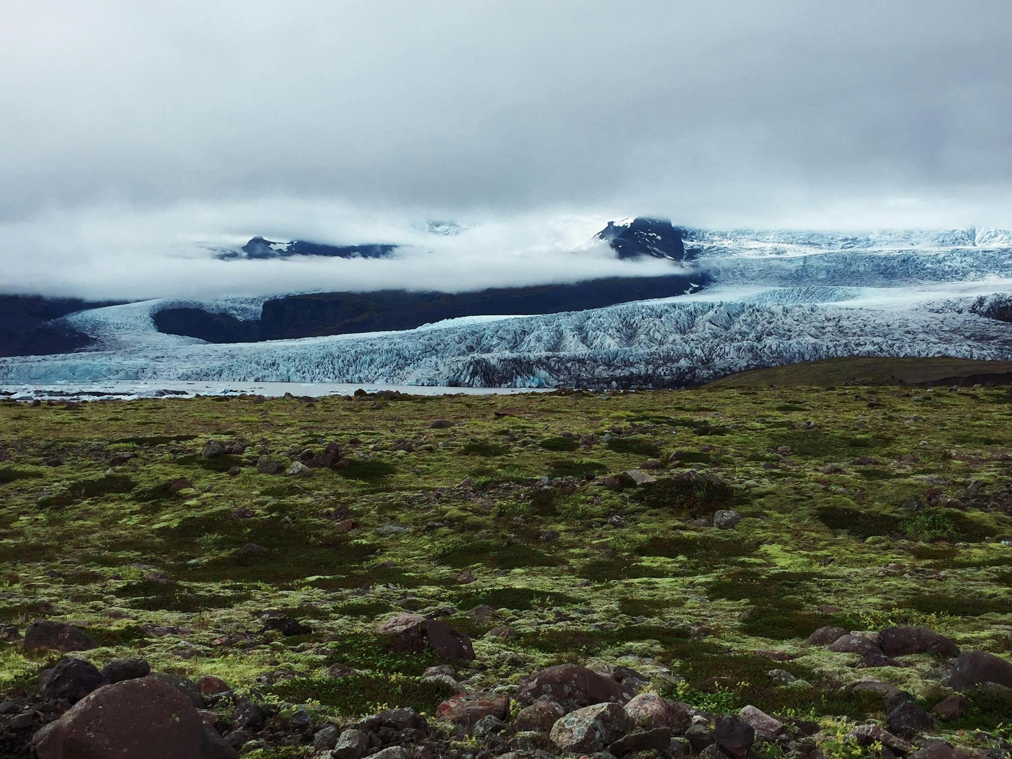 A glacier edge above mossy Breiðamerkursandur inside the Vatnajökull National Park landscape.
