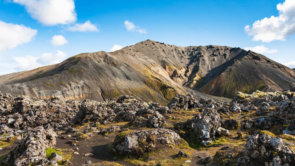 Dark Laugahraun lava and mountain slopes in the Landmannalaugar hiking area near Brennisteinsalda.