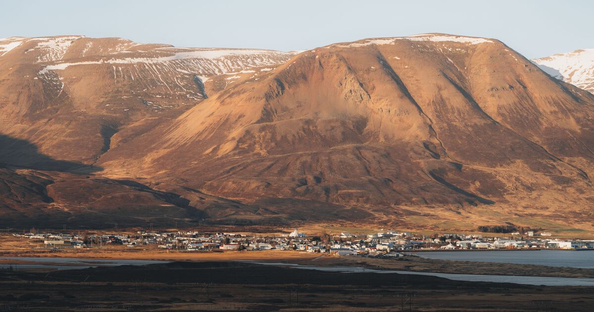 Dalvík town below a snow-streaked mountain on the Tröllaskagi side of North Iceland.