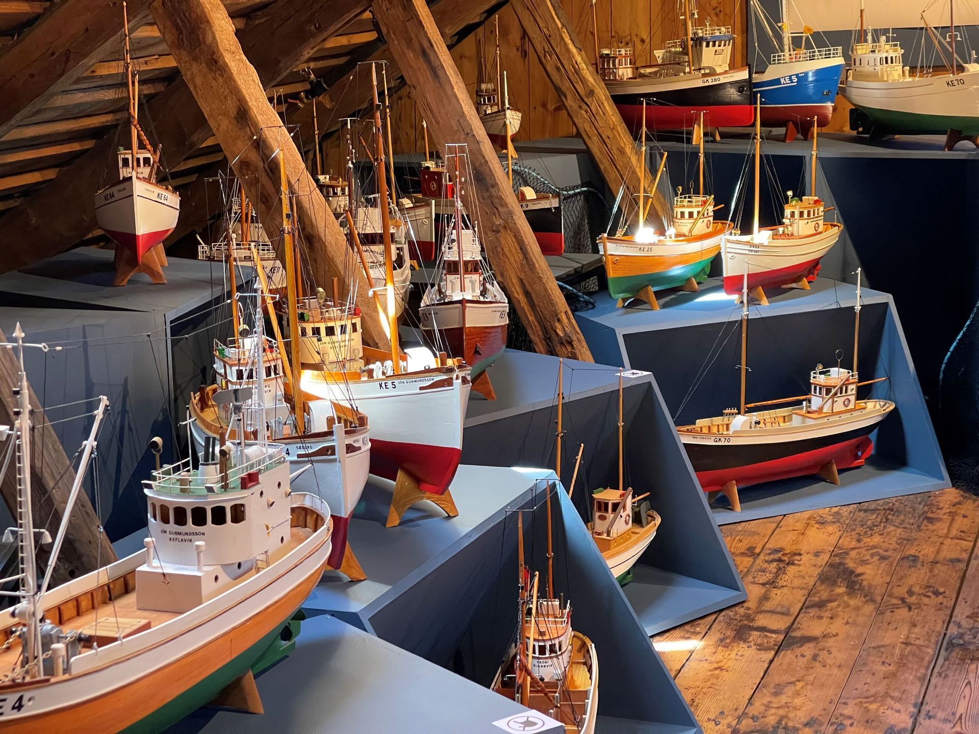 Model fishing boats displayed inside Duus Museum in Keflavík.