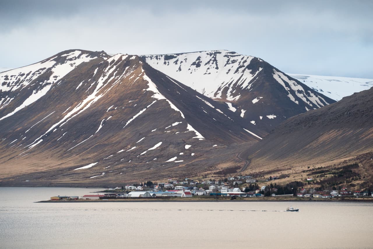 Þingeyri below snow-streaked mountains on the shore of Dýrafjörður.