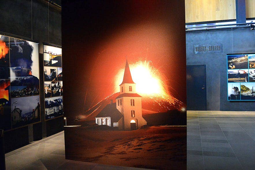 Historic Eldfell eruption photographs displayed inside Eldheimar museum on Heimaey.
