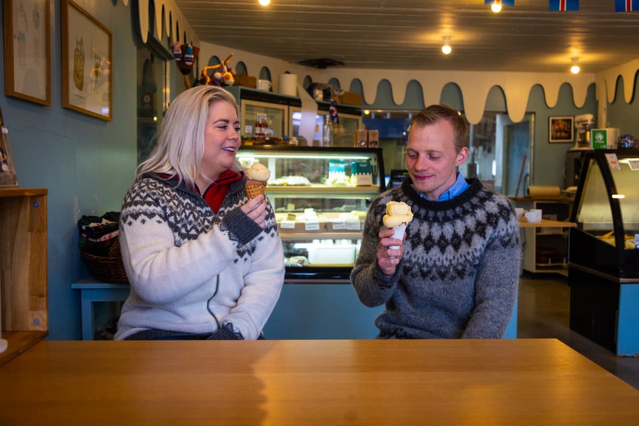 Travelers eating ice cream inside the Erpsstaðir creamery.