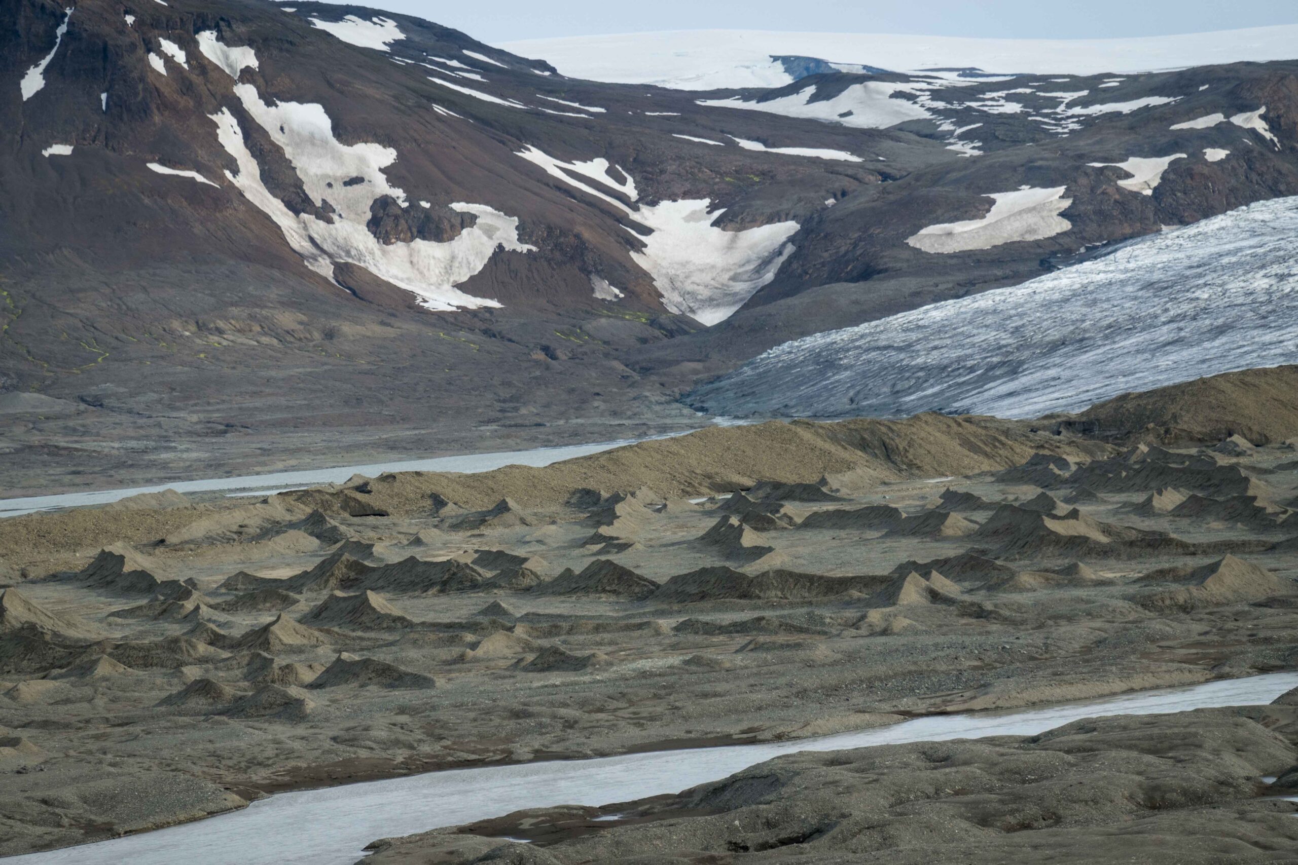 Eyjabakkajökull ice and moraine ridges above pale glacial water.