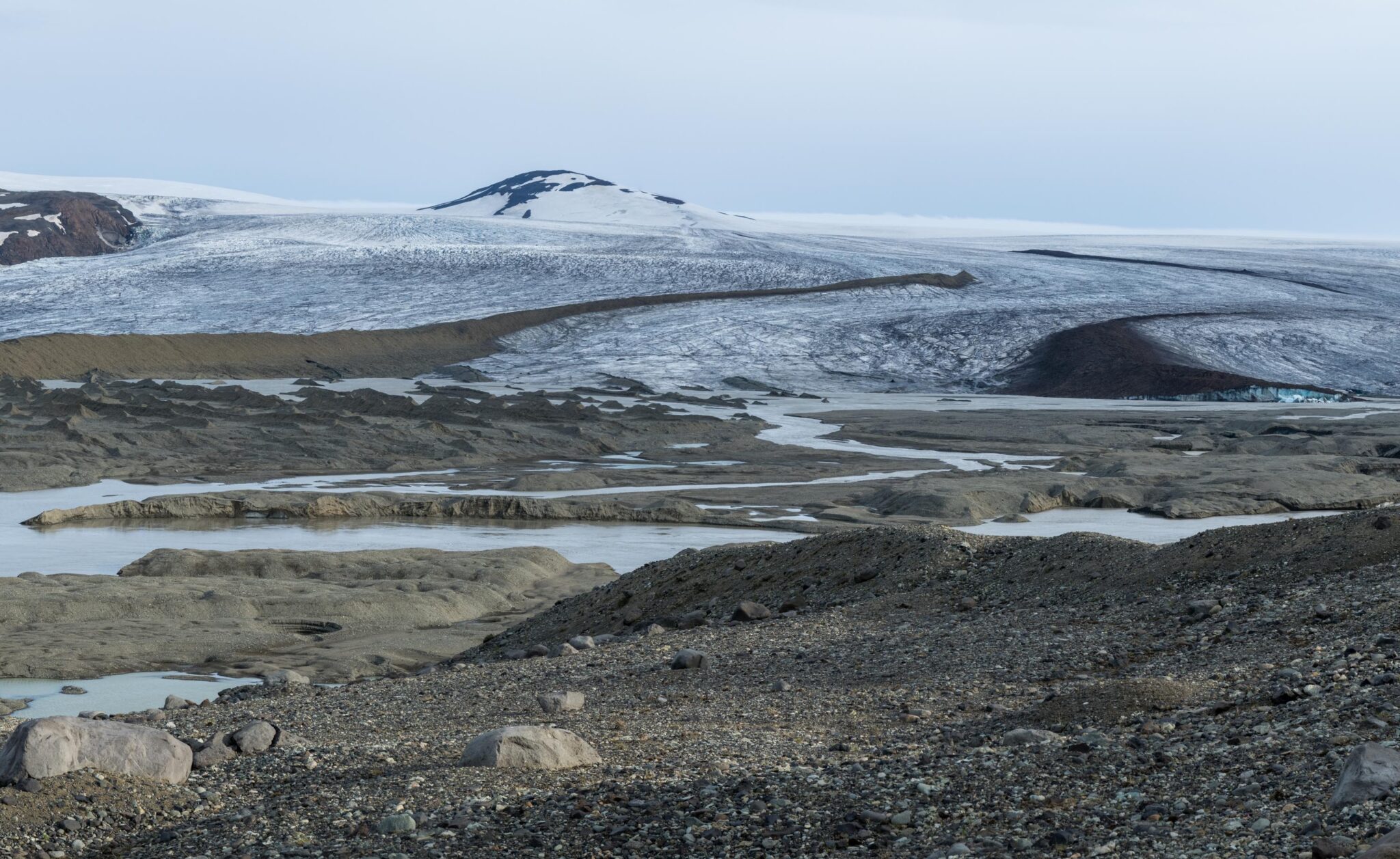 Wide view of Eyjabakkajökull ice, gravel ridges, and pale glacial channels.