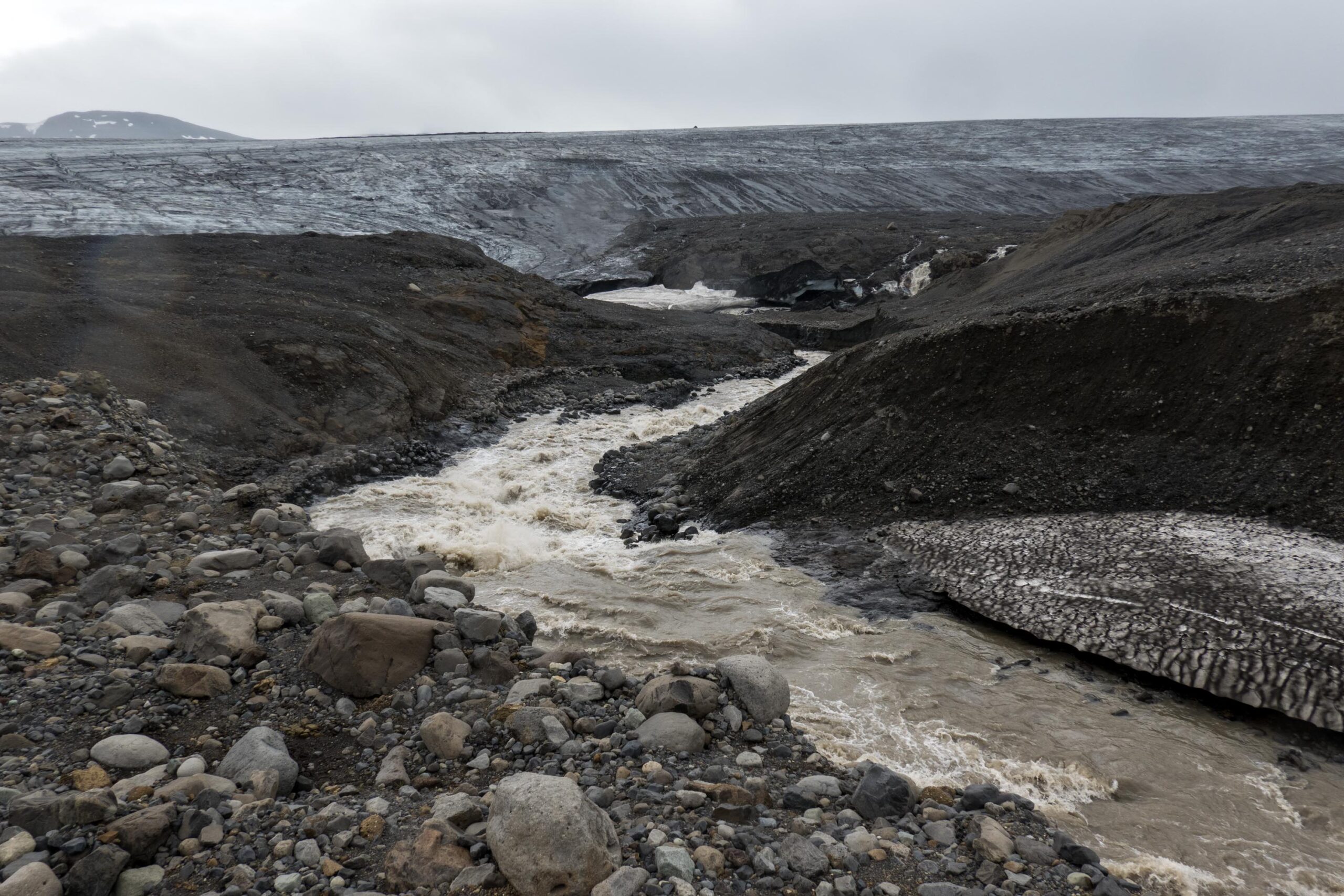 Meltwater and dark moraine below the ice edge of Eyjabakkajökull.