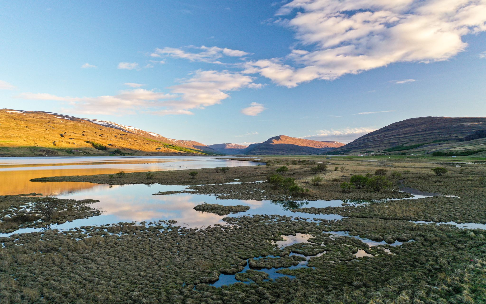 Broad view across Fljótsdalur Valley with braided water, green valley floor, and Lagarfljót stretching through inland East Iceland.