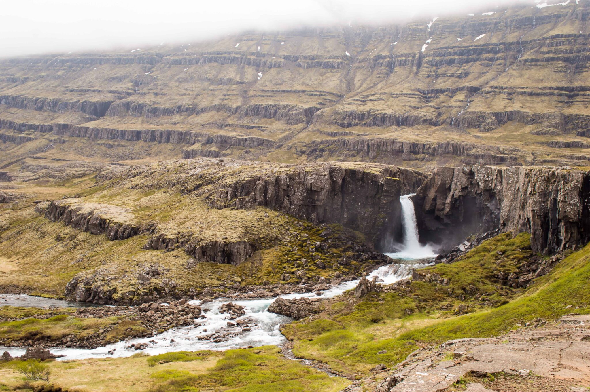 Folaldafoss dropping into a dark basalt basin beside the Öxi road in East Iceland.