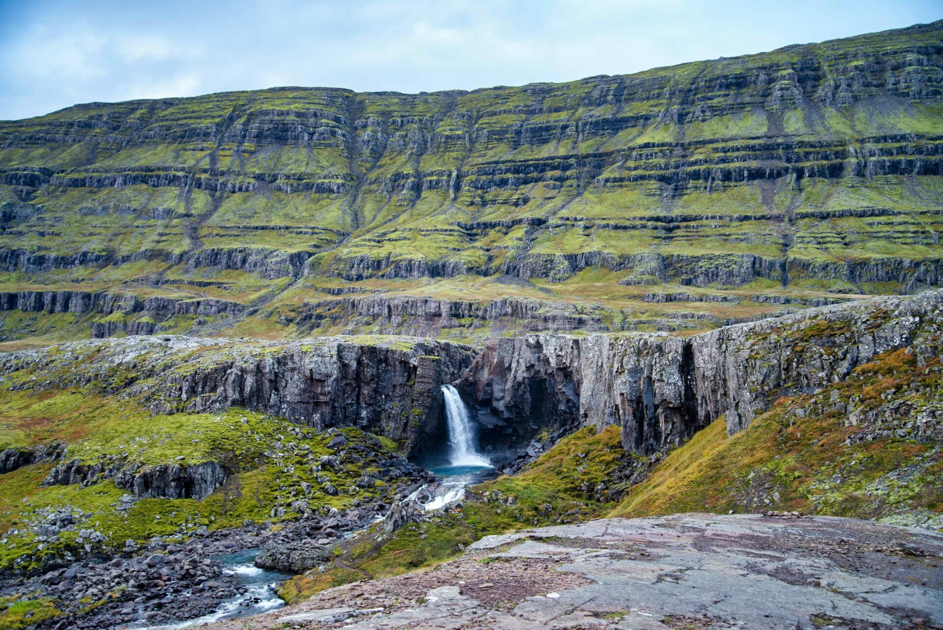 Folaldafoss Waterfall dropping through a dark basalt notch above the Öxi pass in East Iceland.