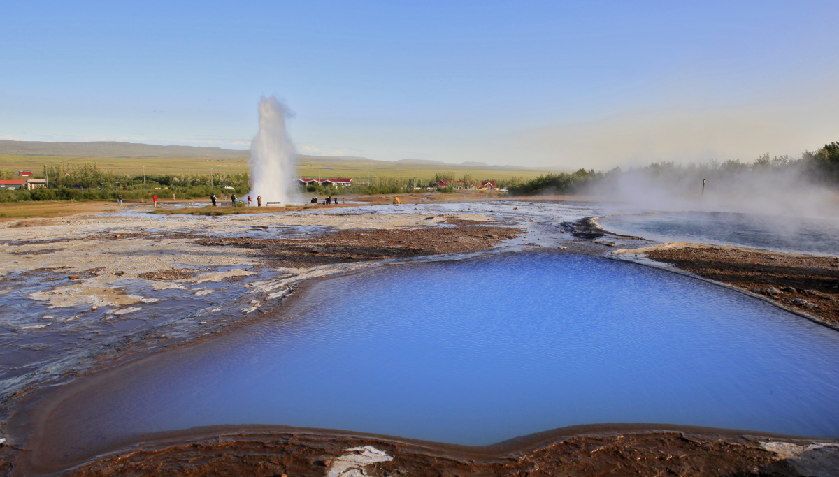 Strokkur erupting across the Geysir geothermal area on the Golden Circle.
