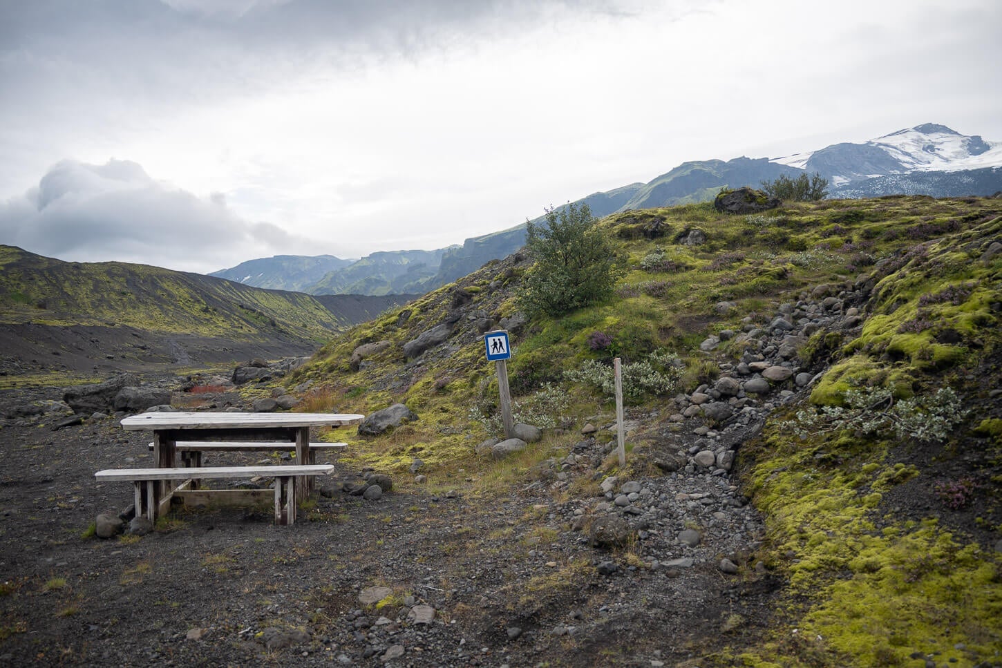A marked walking path and picnic table on the approach toward Gígjökull in South Iceland.