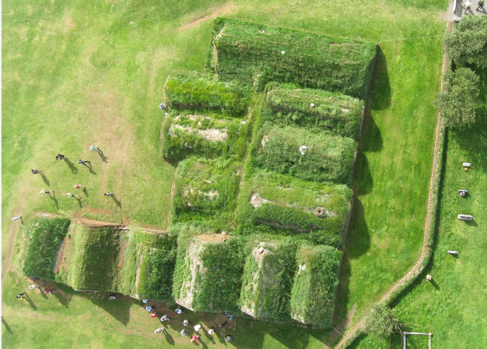 Overview of the Glaumbær turf farm buildings and open Skagafjörður landscape.