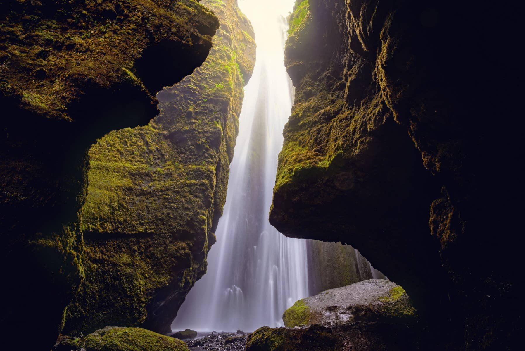 Gljúfrabúi waterfall dropping inside a narrow mossy cleft in South Iceland.