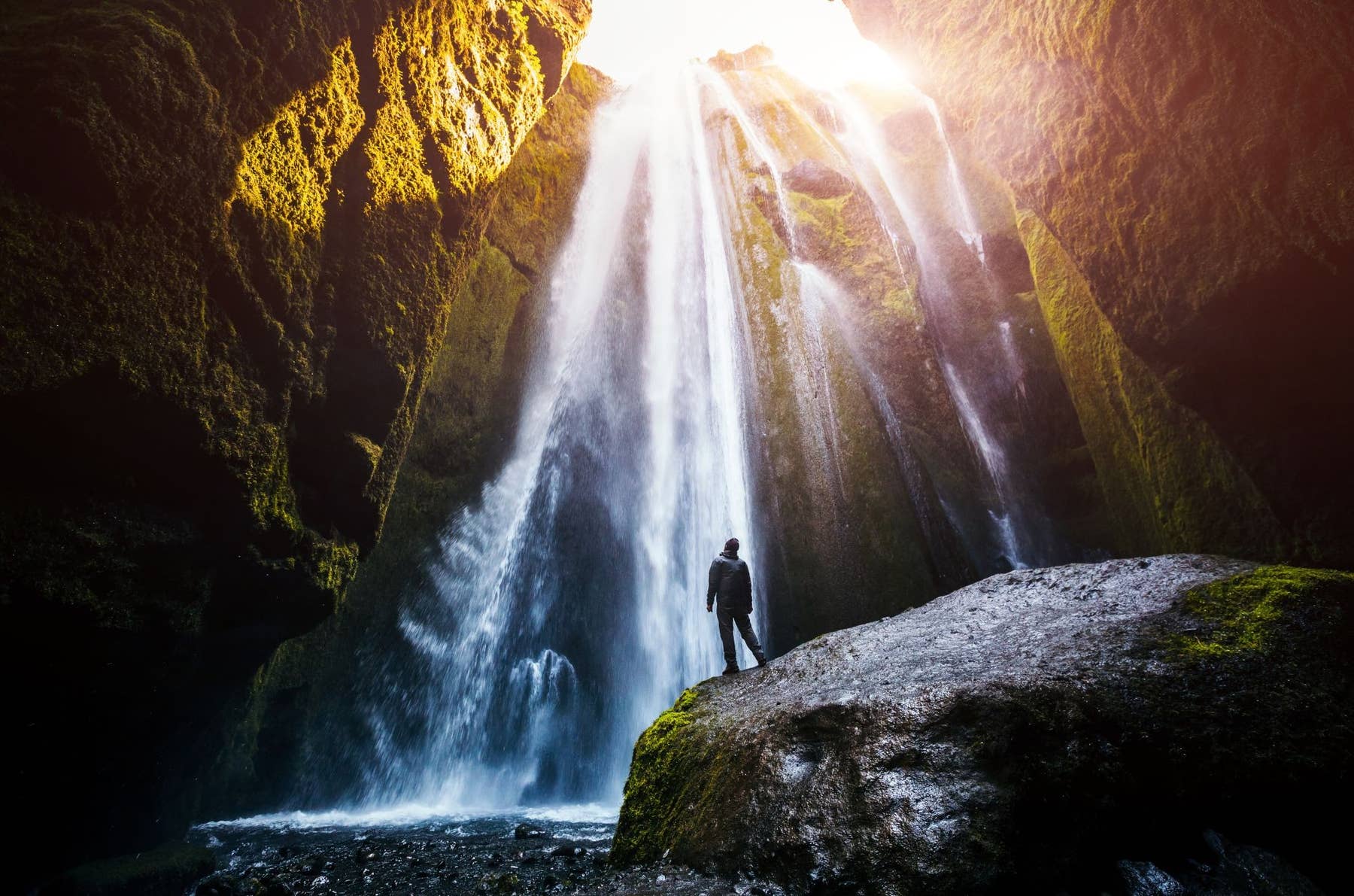 Gljúfrabúi waterfall dropping inside a mossy canyon beside Seljalandsfoss in South Iceland.