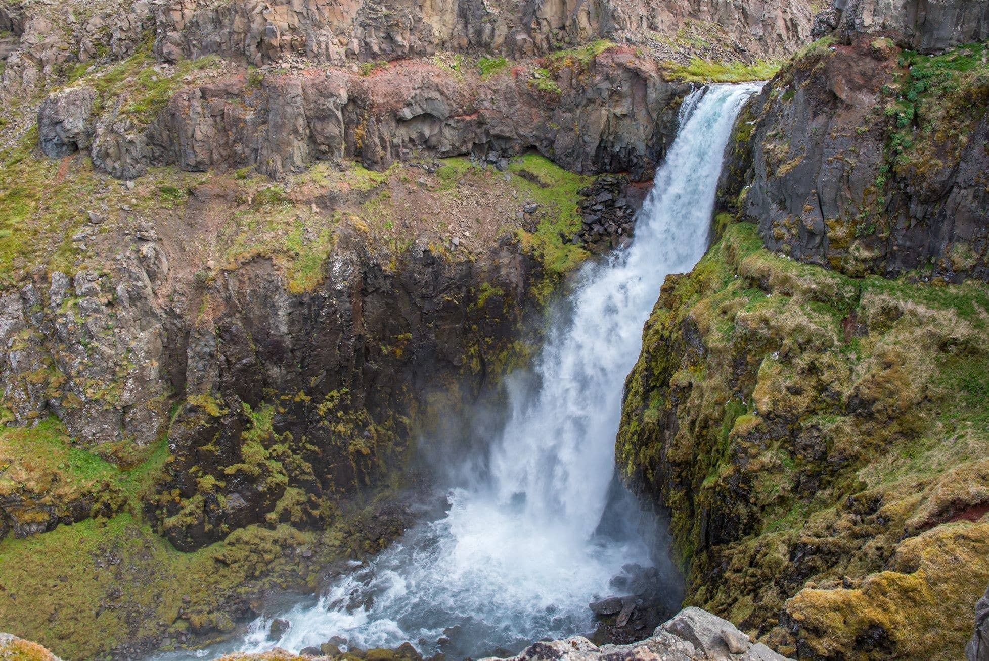 Gljúfursárfoss dropping through a green ravine near Vopnafjörður in East Iceland.