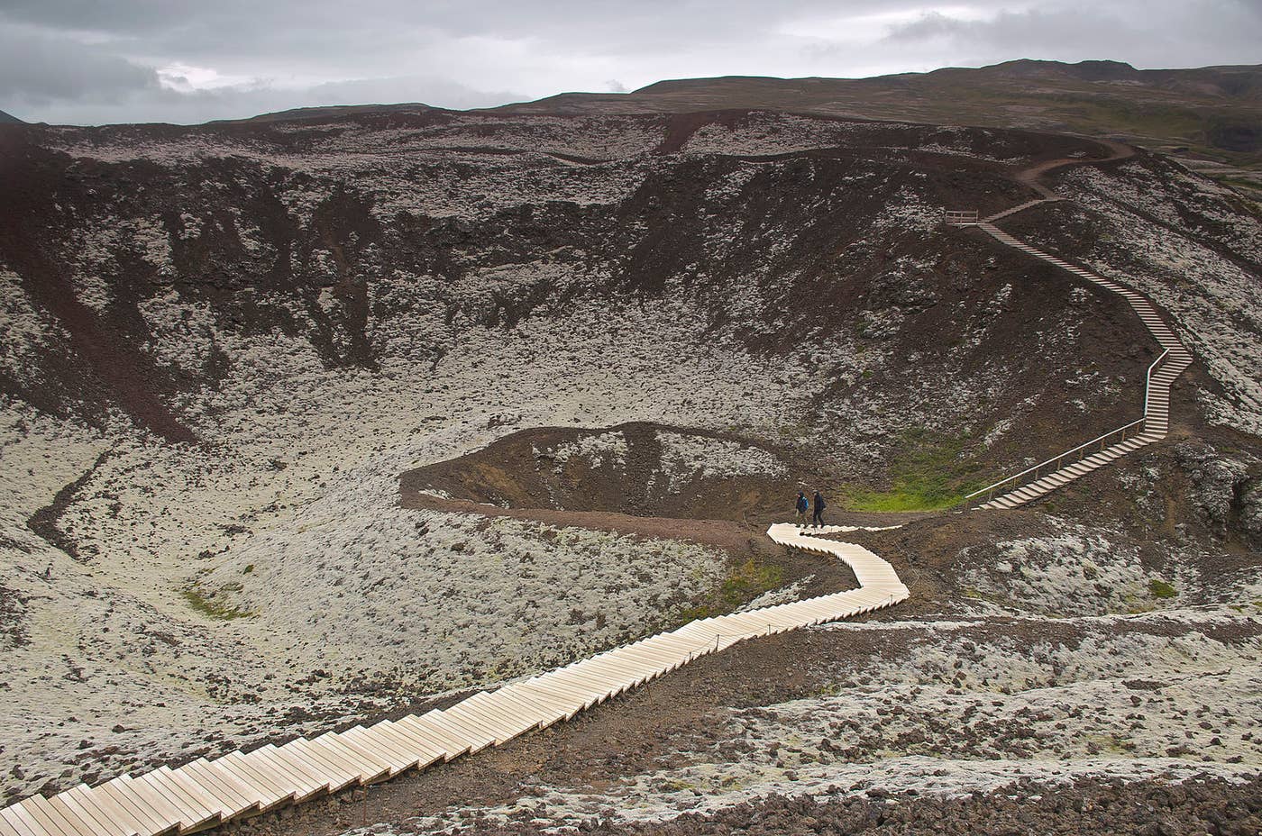 Wooden path crossing the inside rim of Grábrók crater in West Iceland.