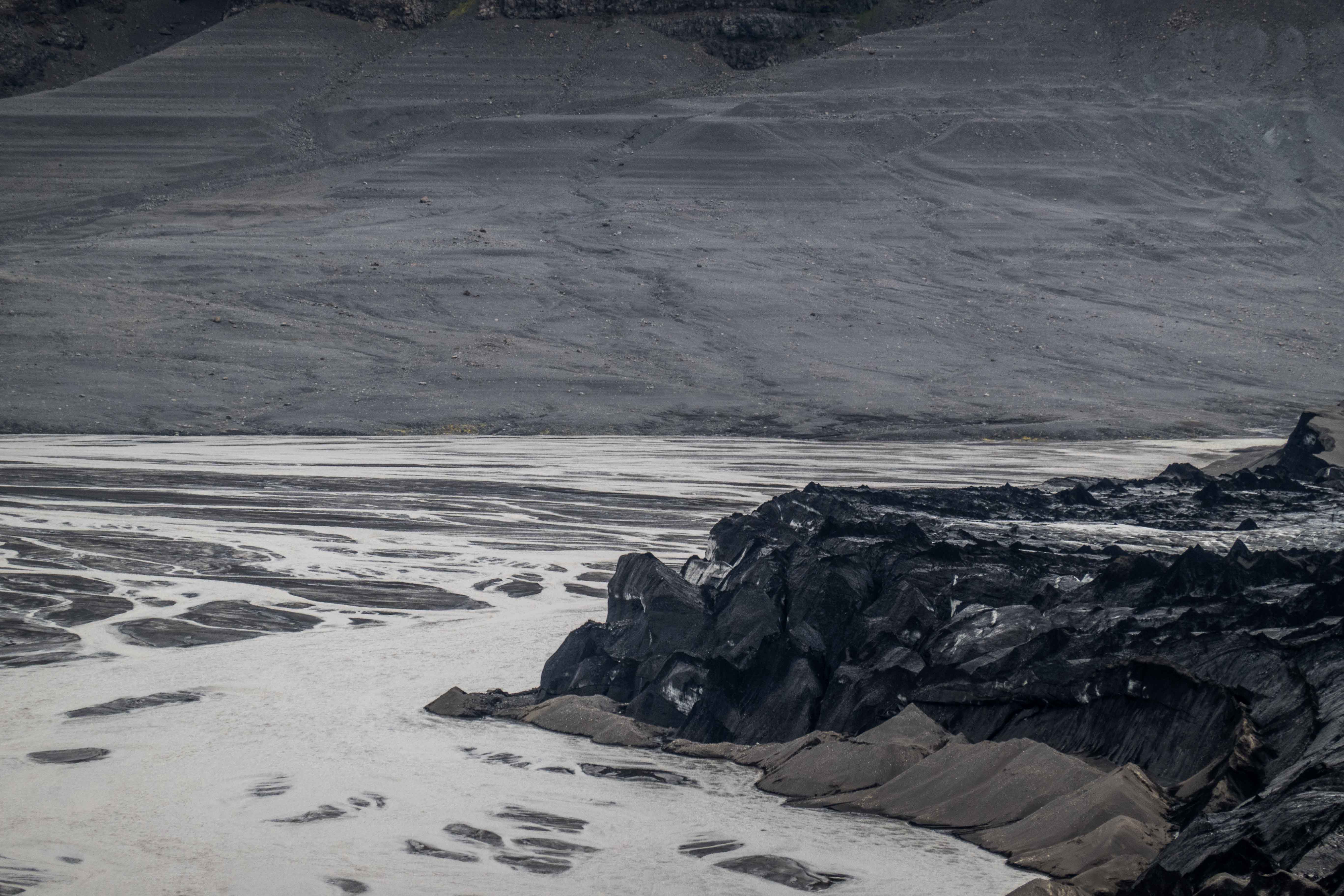 Braided silty channels and broken ice in the former Grænalón basin in South Iceland.