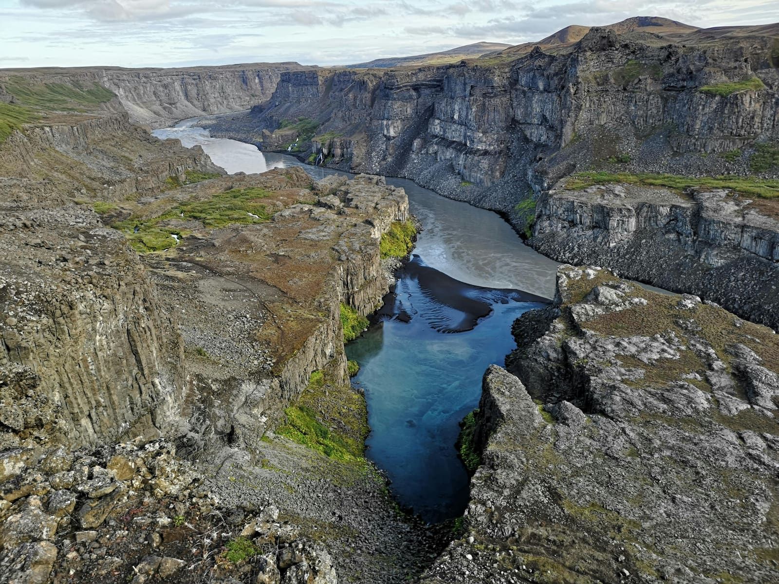 Steep rocky Hafragil lowland terrain below Jökulsárgljúfur canyon walls.