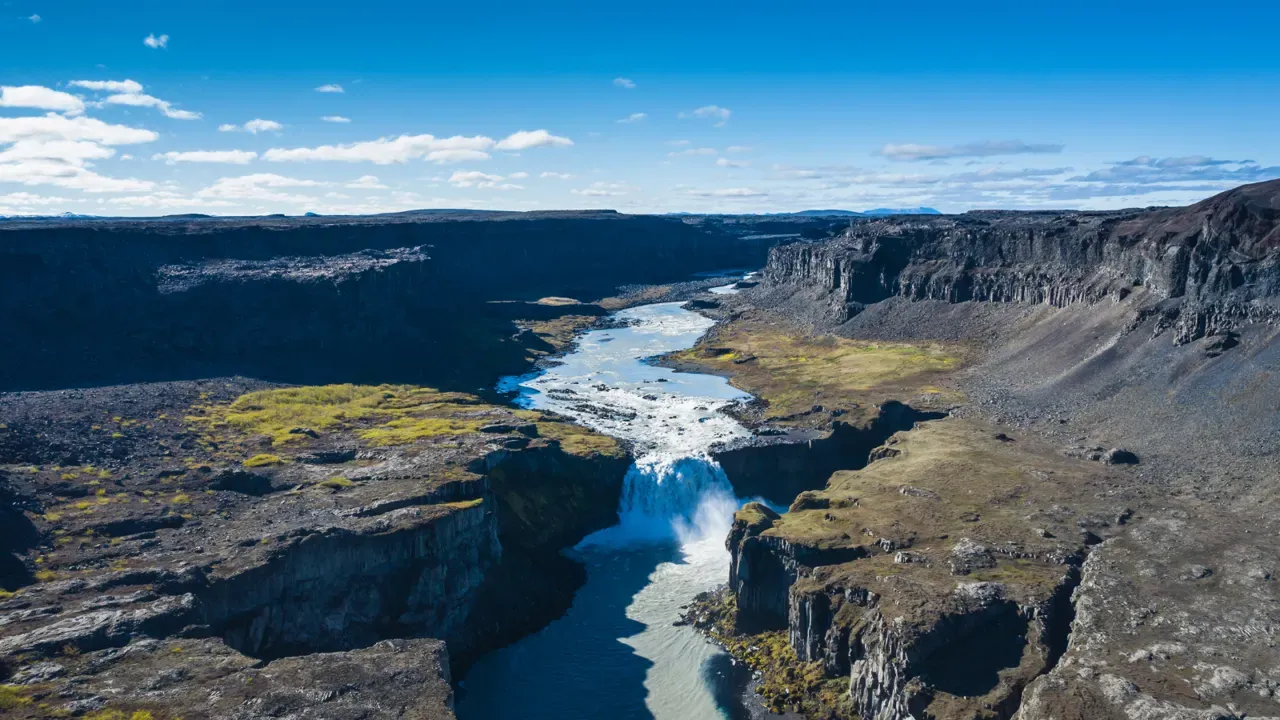 Hafragilsfoss dropping into Jökulsárgljúfur with the glacial river continuing through the canyon.