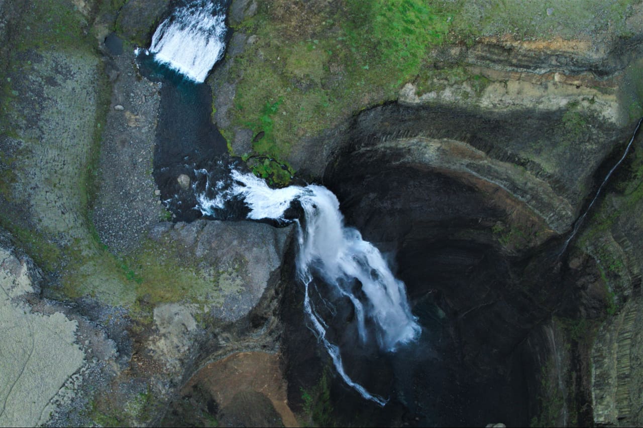 An overhead view of Háifoss dropping from the Fossá river into the dark canyon.