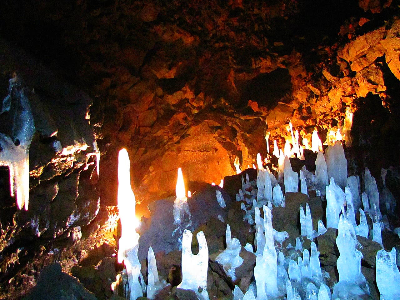 Ice formations and rough lava inside a cave in the Hallmundarhraun lava field.